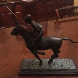 Heavy metal polo player on horse.